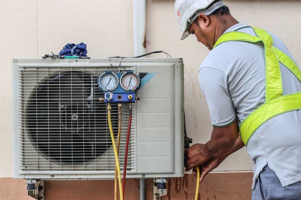 technician installing an AC in Tulsa, OK technician installing an AC in Tulsa, OK