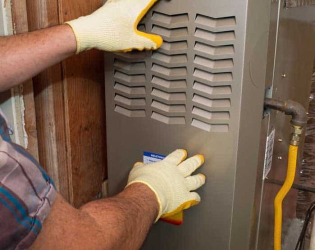 technician repairing heating system Broken Arrow, OK