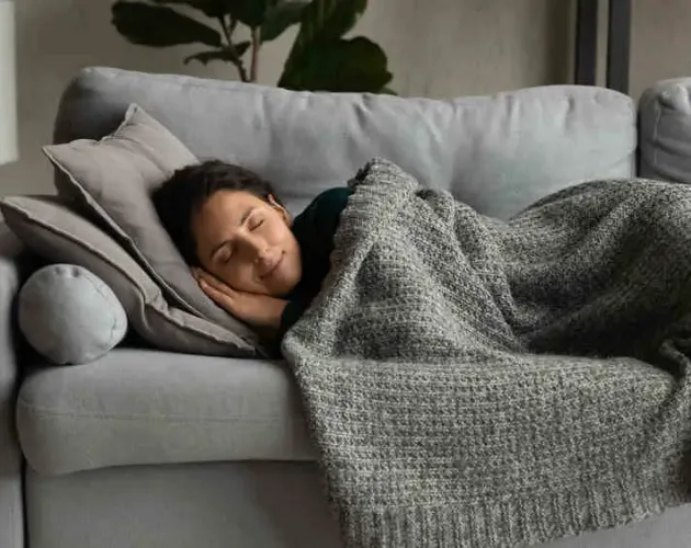 Person bundled up in blankets (for warmth)