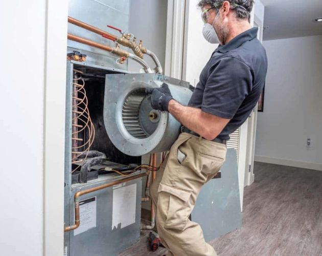 HVAC contractor repairing heat pumps