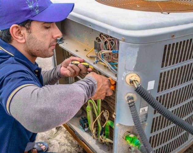 repairman fixing an ACin Broken Arrow, OK
