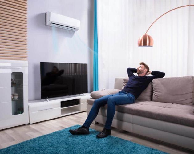 Person enjoying the breeze from an AC vent