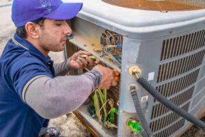 repairman fixing an ACin Broken Arrow, OK